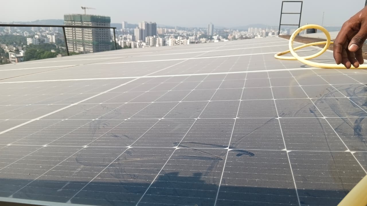 Thick dust layer on Pune rooftop solar modules before cleaning